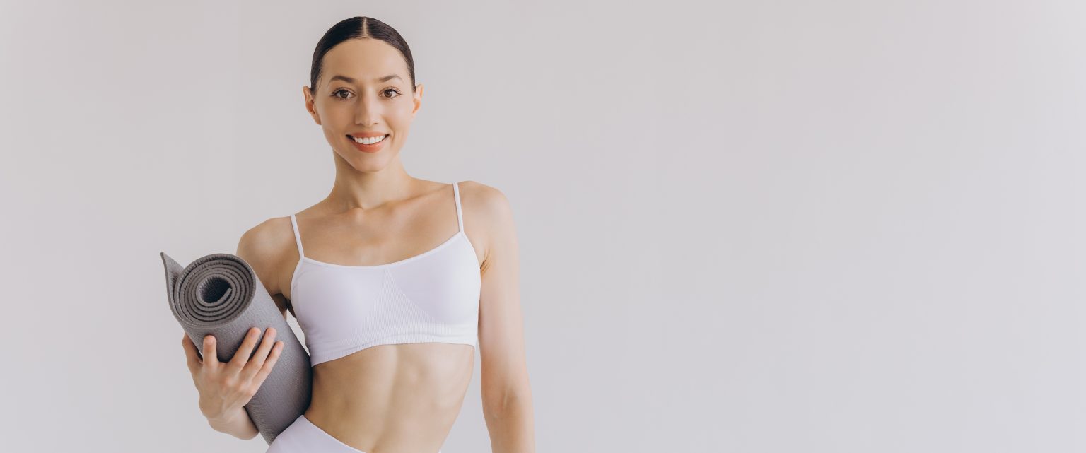 Young woman holding yoga mat isolated on white background, panoramic banner, Sport, fitness, meditation, yoga balance, mindfulness, workout, hobby, healthy lifestyle concept